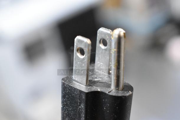 Close-up image of a three-prong electrical plug, likely from the 2024 Avantco 360CPT54 refrigerated prep rail.