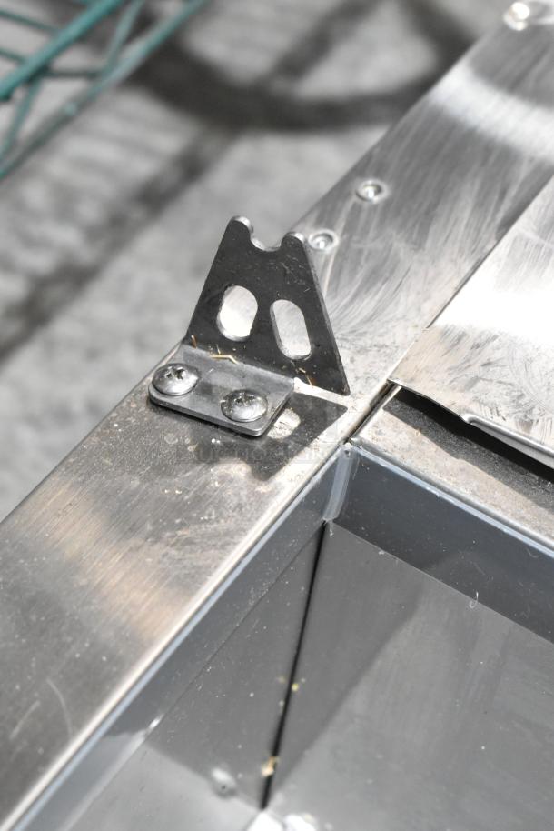 Alt text: Avantco 360CPT54 stainless steel refrigerated prep rail corner detail showing minor scratches. Brand new condition.