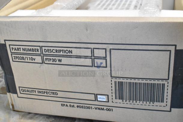 Cardboard box of 2 FTP30 W Insect Light Traps, labeled as new with scratch and dent. Part number ZF028/110V visible.