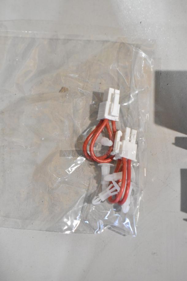 Brand new 2024 Hobart 00-975125 unit, scratch and dent condition, sealed in plastic bag, red and white wiring connectors visible.