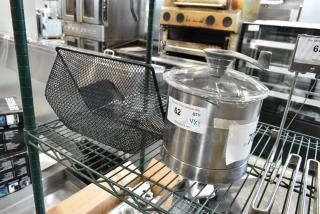 Brand new Robot Coupe 27338 stainless steel bowl assembly and black mesh unit on a rack. Auction label visible.