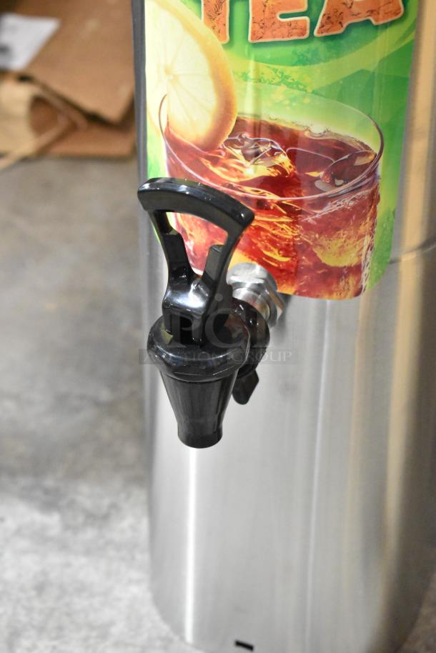BRAND NEW SCRATCH AND DENT Fetco ITD-1235 3.5 Gallon Iced Tea Dispenser, features a durable stainless steel body with a black spigot.