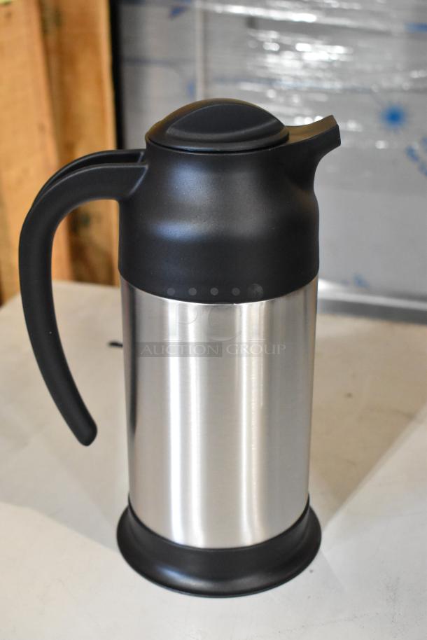 Stainless steel insulated carafe with black lid and handle, brand new, 34 oz capacity.