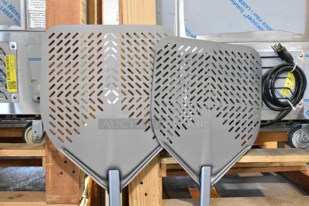 Nine brand new scratch and dent pizza peels, various sizes, perforated design, metal construction, auction listing.