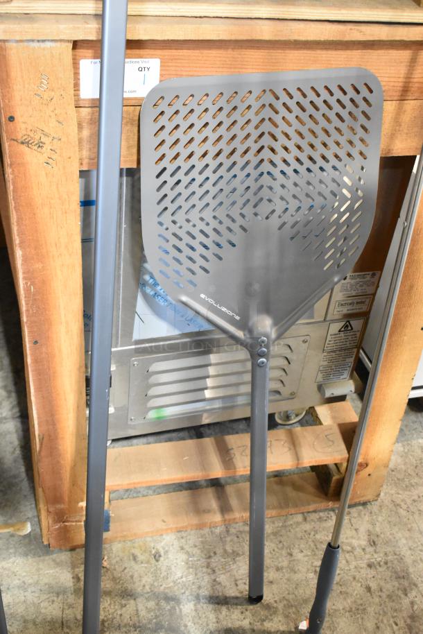 Brand new Evoluzione pizza peel, perforated design, long handle. Nine available, minor cosmetic scratches, durable metal.