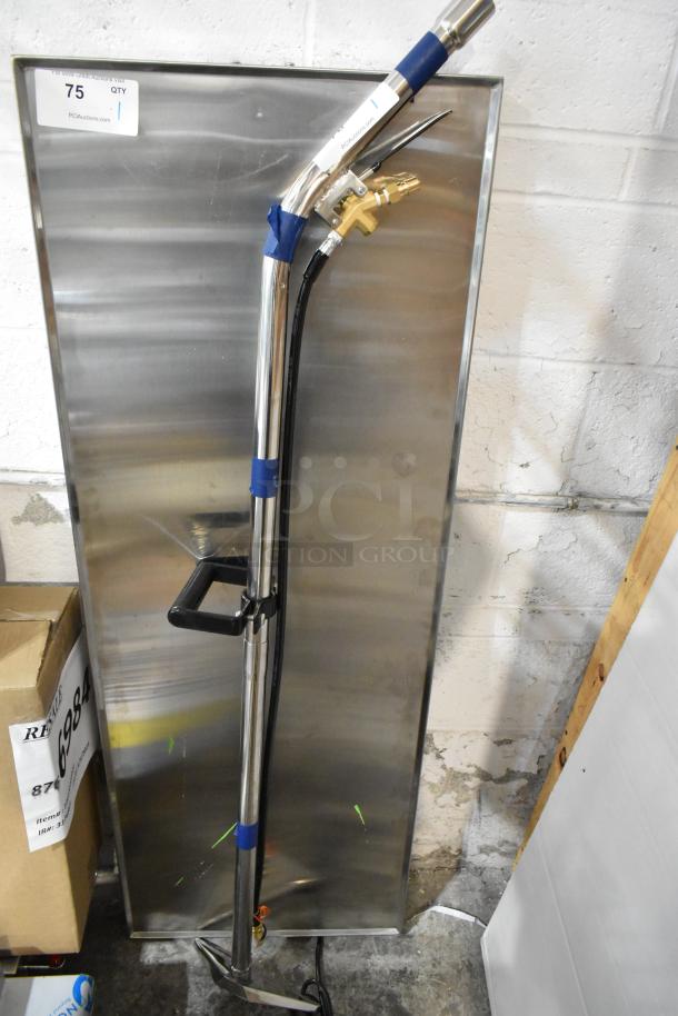 Brand new scratch and dent cleaning machine attachment with stainless steel finish, includes handle and hose. Auction tag visible.