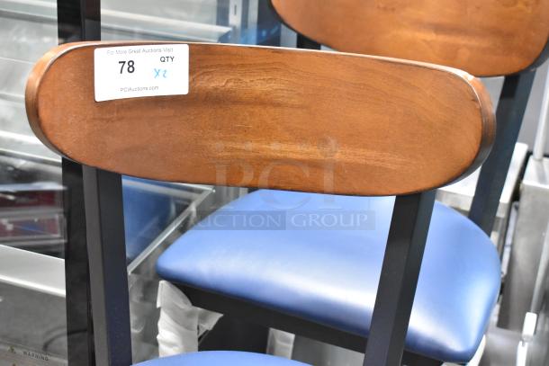 Brand new black metal bar chair with wooden backrest, blue seat cushion. Scratch and dent. Tag: "78 QTY 2".