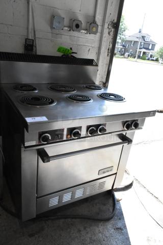 Garland stainless steel 6-burner range with oven, commercial casters, electric, 120/250V, 3 phase, in good condition.