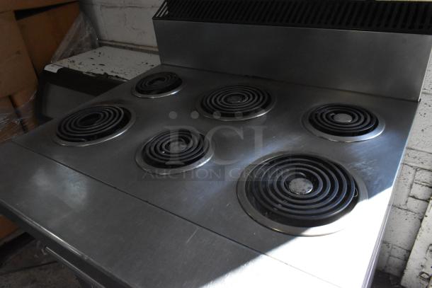 Garland stainless steel commercial 6 burner electric range with oven, 120/250 volts, 3 phase, on casters, good condition.