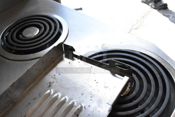 Garland stainless steel electric 6-burner range with oven, commercial casters, 120/250V, 3-phase, shown with coil burners.