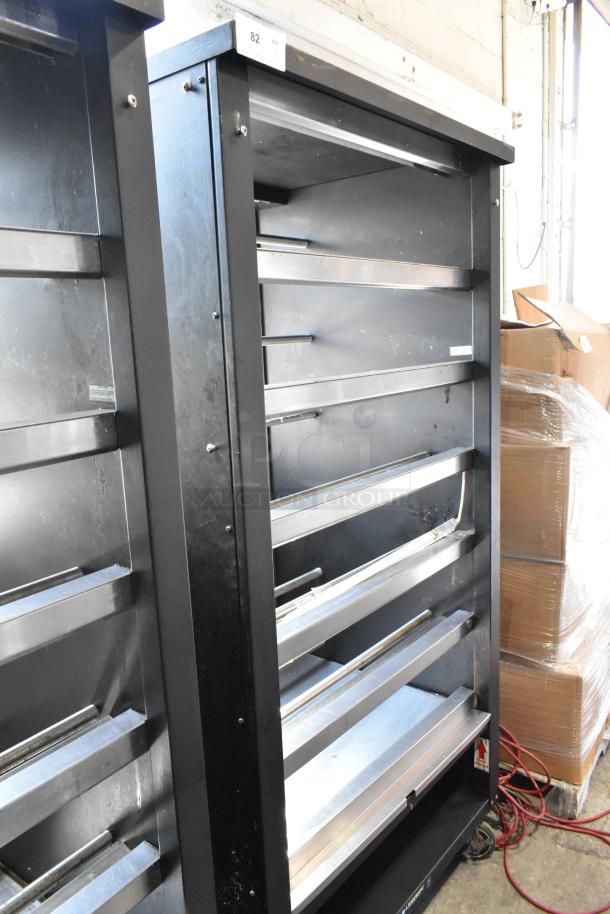 Lakeside metal bakery display rack with multiple shelves, black finish, on commercial casters for mobility, used condition.
