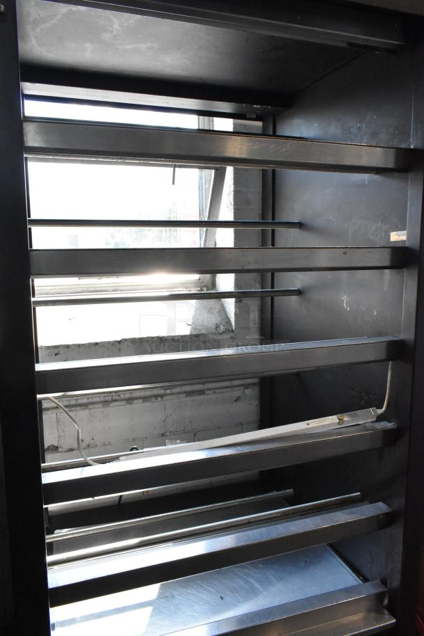 Lakeside metal bakery display rack on casters. Shelves are set for bagels, pastries, or donuts. Commercial-grade, used condition.