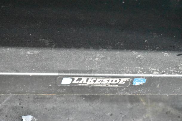 Lakeside metal display rack, sturdy condition, with commercial casters. Label shows Lakeside branding, NSF certification.