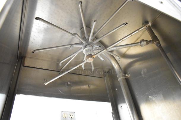 Jackson 150B stainless steel commercial dishwasher, straight pass through design. Internal spray arm detail. 208/220 Volts, 3 Phase.