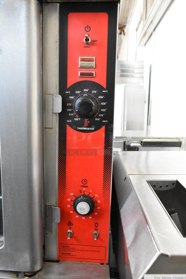 Stainless steel commercial convection oven with view-through doors, metal racks, and thermostatic controls on casters.