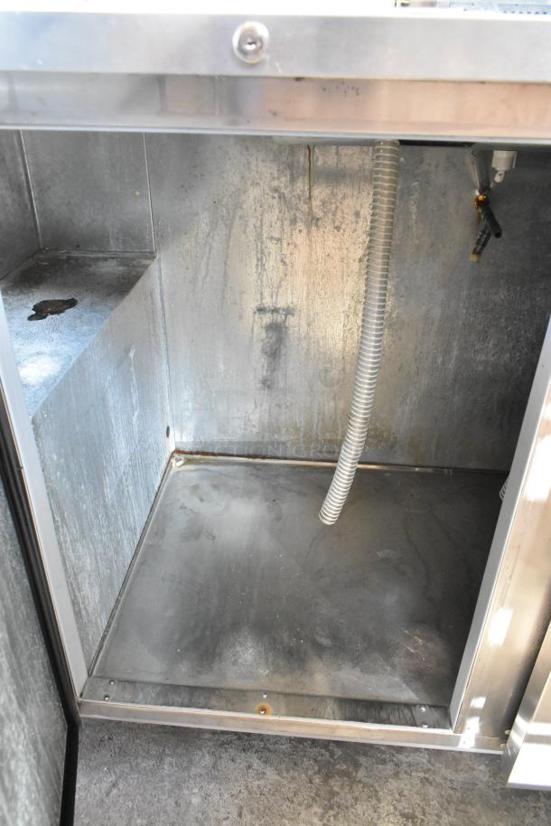 Beverage Air DD58HC-1-S kegerator interior, stainless steel, visible light wear, includes coiled hose, on commercial casters.