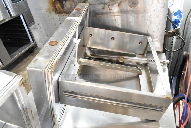 Two stainless steel cooler drawers with visible wear and rust spots, highlighting durability. Ideal for commercial use.