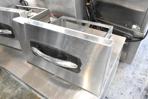 Two stainless steel cooler drawers with handles, heavy-duty construction, industrial use, auction item offering twice bid value.