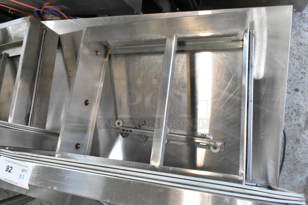 Two stainless steel cooler drawers, sturdy construction, slight wear, includes sliding mechanisms, marked "92," doubles bid.