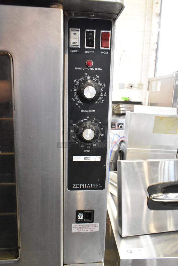 Blodgett stainless steel commercial convection oven, gas-powered, view-through doors, metal racks, thermostatic controls.