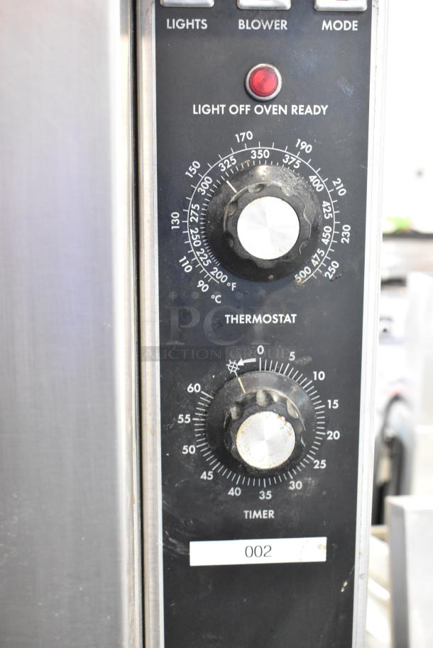 Blodgett stainless steel commercial gas convection oven with view-through doors, metal racks, and thermostatic controls.