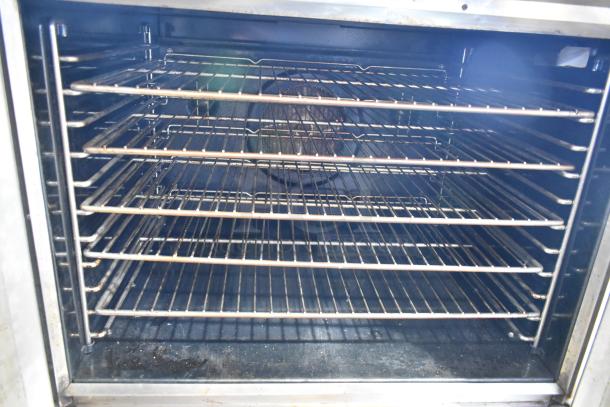 Blodgett stainless steel commercial convection oven, gas-powered, full-size, with view-through doors and metal racks.