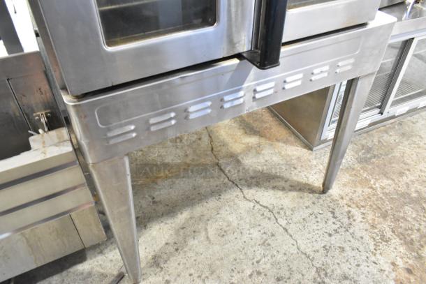 Blodgett stainless steel convection oven with view-through doors, gas-powered, metal racks, thermostatic controls, on metal legs.