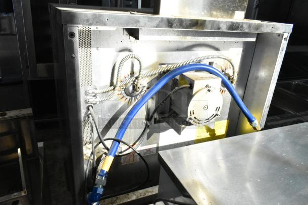 Blodgett stainless steel commercial gas convection oven back view; visible wiring and connections; sturdy construction.