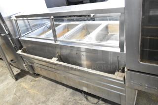 APW Wyott TM-90D stainless steel 4-bay steam table; includes tray slide, sneeze guard, under shelf; on commercial casters.