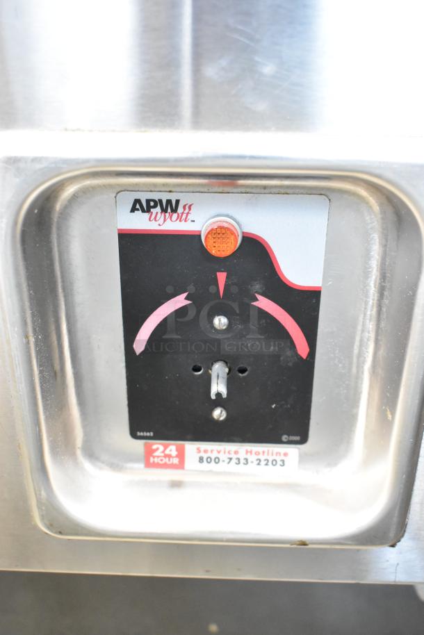 APW Wyott TM-90D steam table control panel with service hotline label, set in stainless steel.