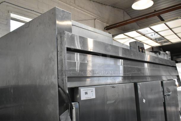 Traulsen RDT332NUT-HHS stainless steel three-section refrigerator/freezer, 60.7 cu. ft., metal racks, on commercial casters.