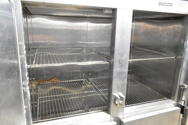 Traulsen RDT332NUT-HHS stainless steel commercial refrigerator/freezer, 60.7 cu. ft., three-section, six half doors, metal racks, on casters.