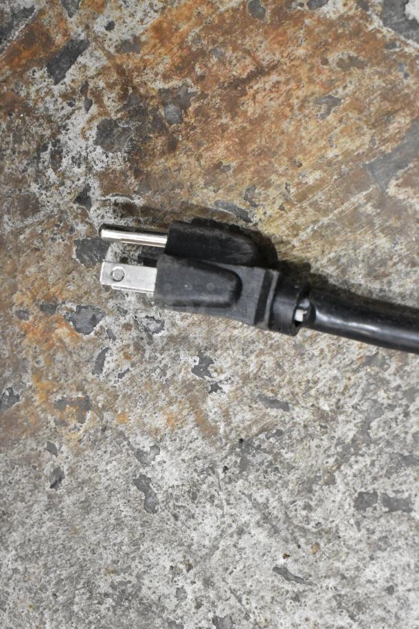 Close-up of a Hatco CHW-43 food warmer plug on a textured surface, showing a standard 120-volt connector.