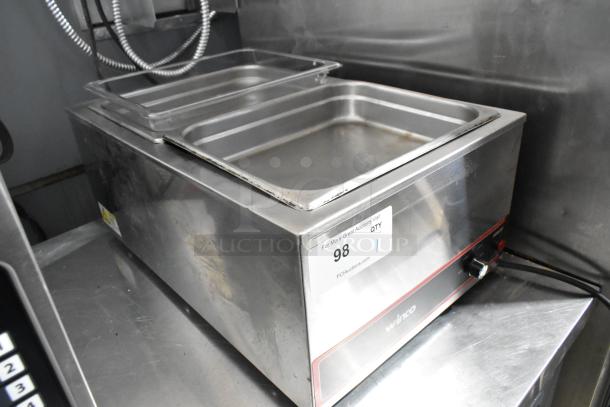 Winco FW-S500 stainless steel food warmer, 120 volts, 1 phase. Includes two pans, visible wear. Model FW-S500.