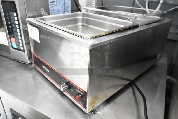 Winco FW-S500 stainless steel food warmer, 120V, 1 phase. Shows heating dial and Winco logo. Slight wear visible.