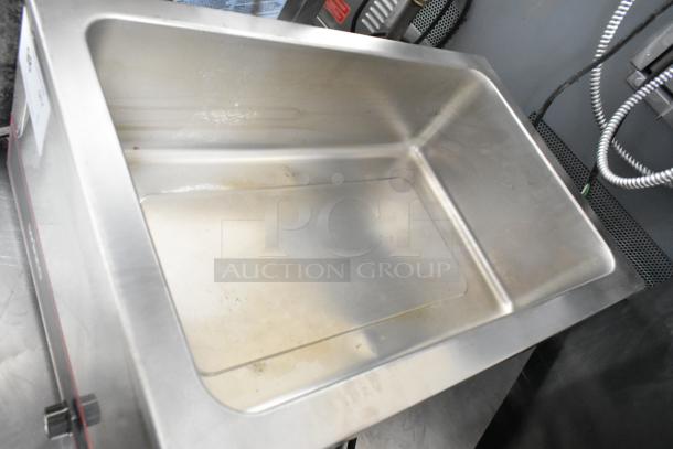 Winco FW-S500 stainless steel food warmer, 120 volts, 1 phase. Clean, used condition with visible minor wear.