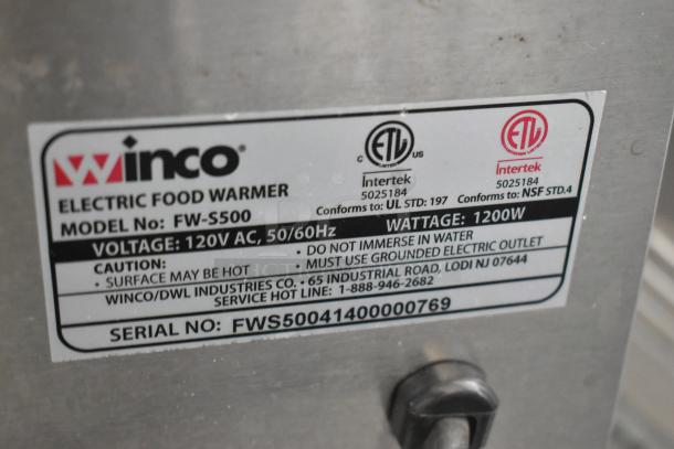Winco FW-S500 stainless steel food warmer with label showing voltage 120V, wattage 1200W, and safety warnings.