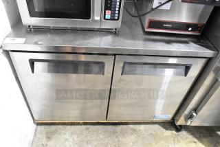 Turbo Air MUF-48 stainless steel commercial 2-door undercounter freezer on casters, excellent condition, with visible control panel.