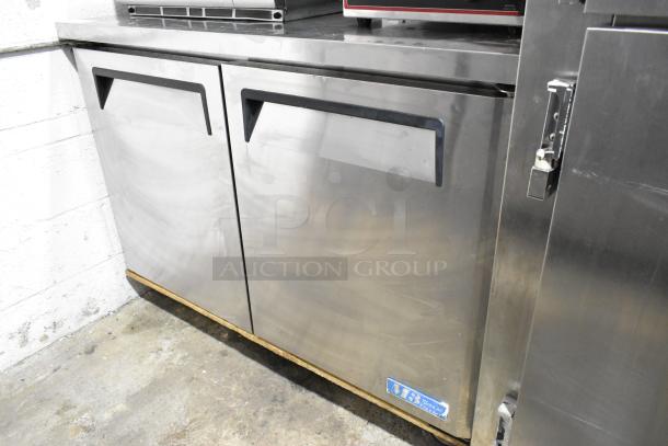 Turbo Air MUF-48 stainless steel undercounter freezer on casters, featuring two doors and durable design for commercial use.