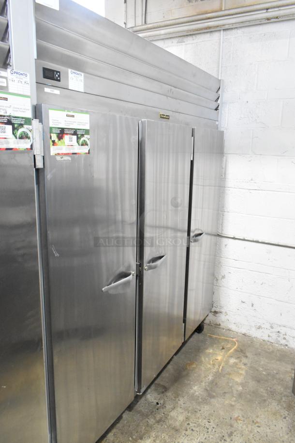 2018 Traulsen G30010 stainless steel 3-door reach-in cooler with poly coated racks, locked doors, on commercial casters.