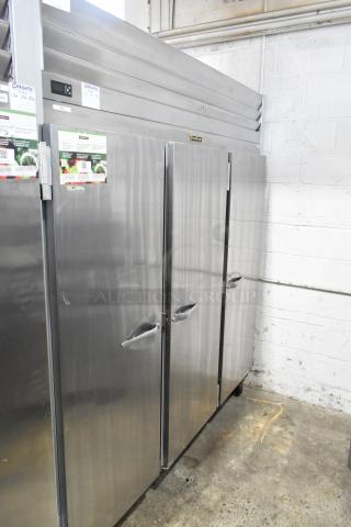 2018 Traulsen G30010 stainless steel 3-door reach-in cooler with poly coated racks, locked doors, on commercial casters.