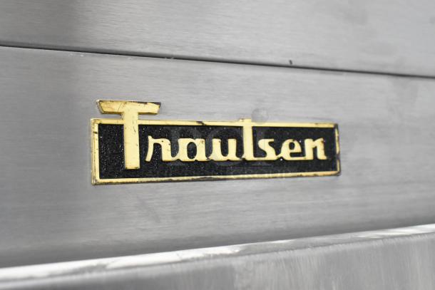 Traulsen G30010 logo on stainless steel surface of 2018 commercial 3-door reach-in cooler, locked doors.