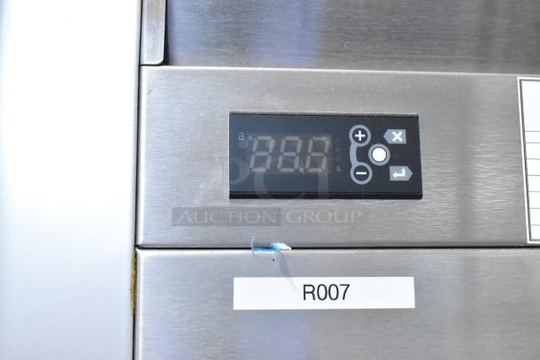 2018 Traulsen G30010 stainless steel 3-door cooler, digital display, label "R007", commercial casters, locked.