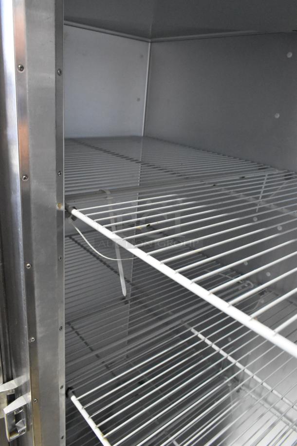 2016 Traulsen G20010 stainless steel 2-door cooler with poly-coated racks and commercial casters. Left door locked.