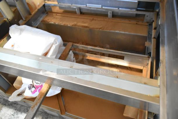 Delfield DD4464N-12-DD4 stainless steel prep table interior, showing storage area and shelving, in used condition.