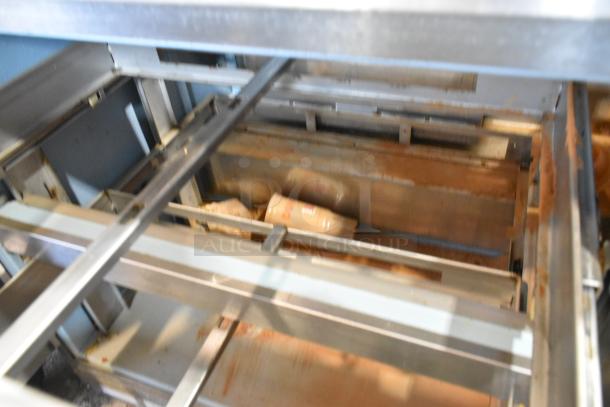 Delfield DD4464N-12-DD4 sandwich prep table with over shelf, stainless steel, visible internal mechanics, used condition.