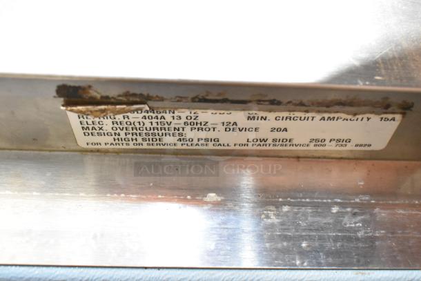 Delfield DD4464N-12-DD4 prep table label showing electrical specs: 115V, 12A, design pressures, refrigerant type.