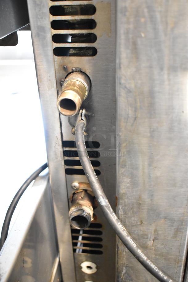 Baxter stainless steel mini rotating rack oven, natural gas powered, with visible wiring and connections; moderate wear.