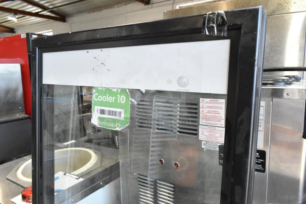 Glass door for merchandiser with black frame, visible label "Cooler 10," signs of wear, and safety stickers displayed.