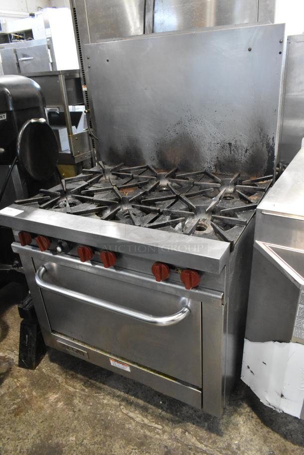Vulcan stainless steel commercial gas 6-burner range with oven and backsplash, used, visible wear, red knobs.